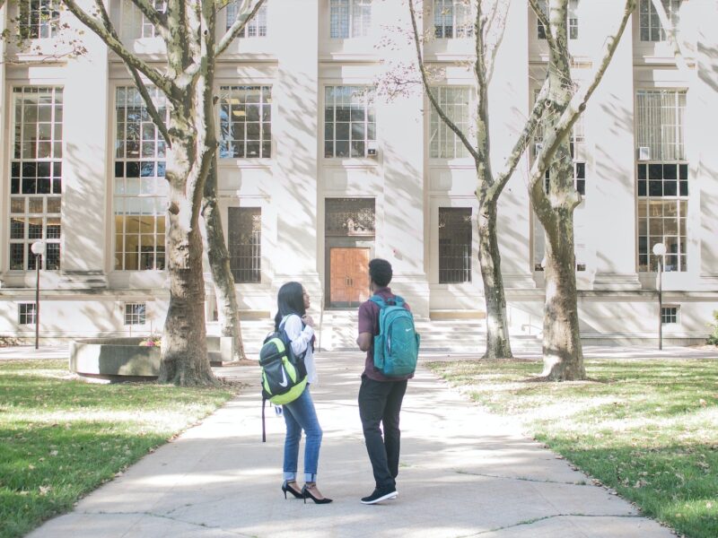 a couple of people that are standing in front of a building