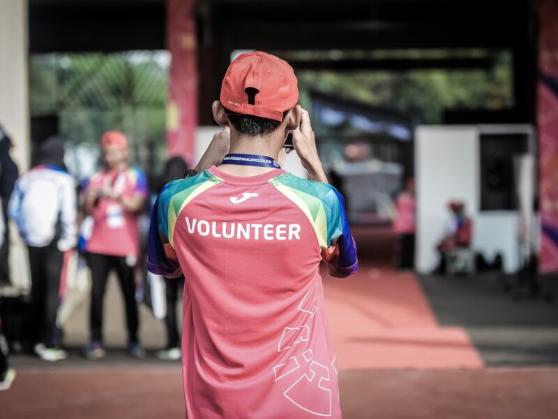 person standing wearing red shirt