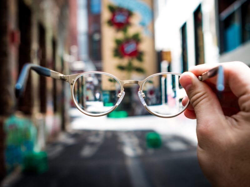 person holding eyeglasses